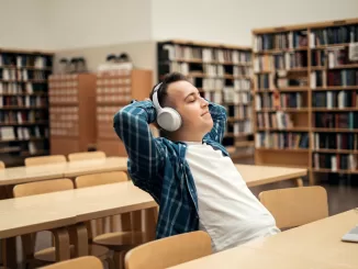 a man listens to music and an audiobook with headphones gets pleasure