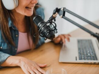 Woman in headphones recording podcast