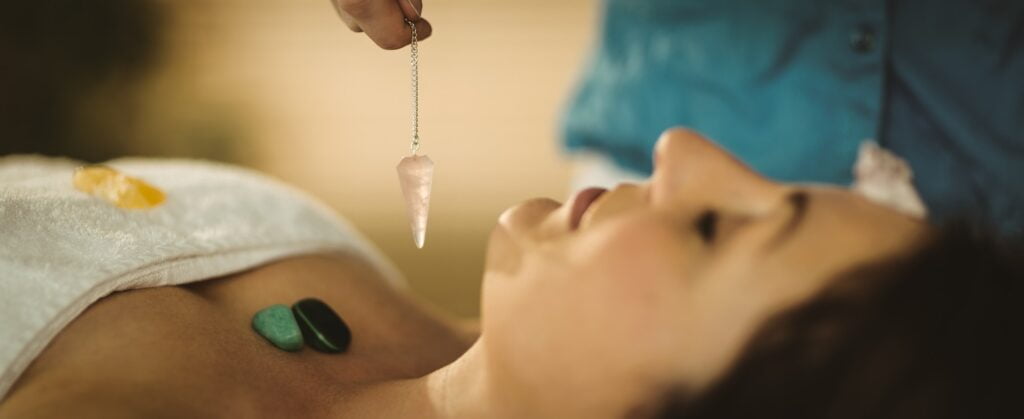 Young woman at crystal healing session in therapy room