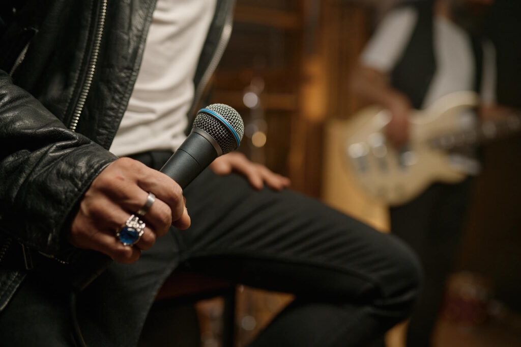 A performer holding a dynamic microphone, a robust choice for musicians and live performers seeking the best microphone for YouTube videos.